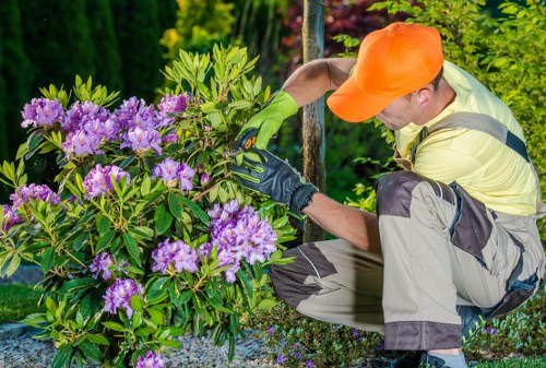 A gardener using protected tools during routine maintenance